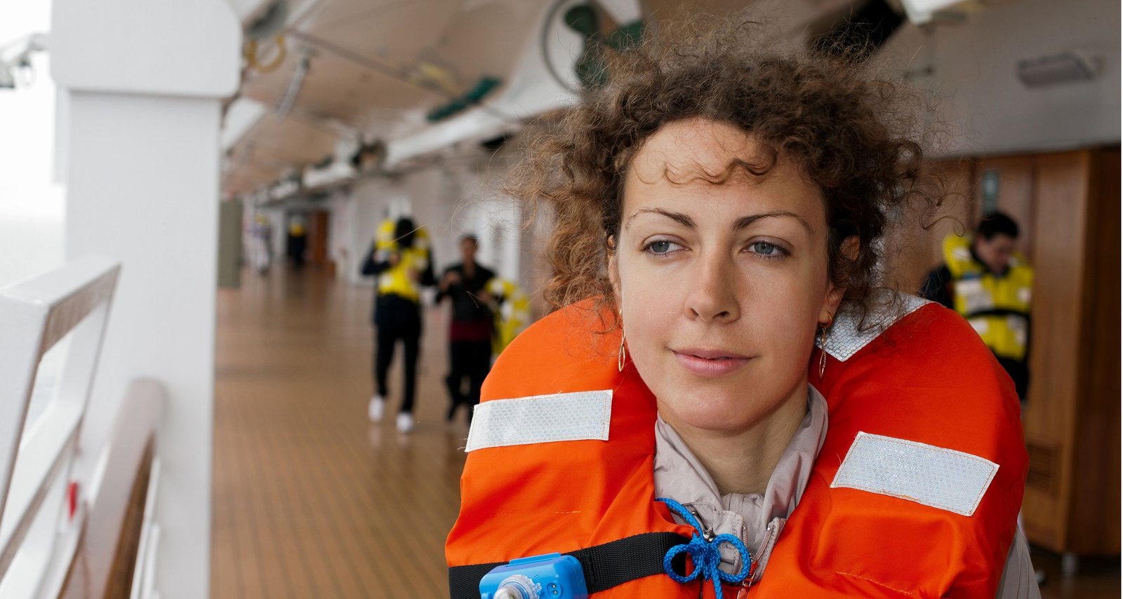 Passenger in a life jacket aboard a vessel